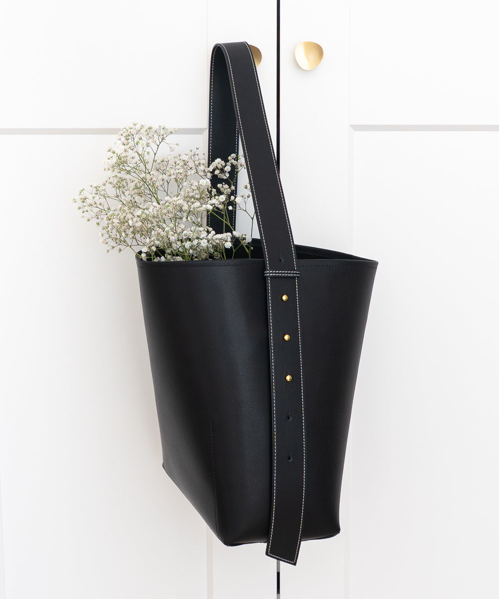 AALLYN Jolina leather bucket tote styled as a flat lay