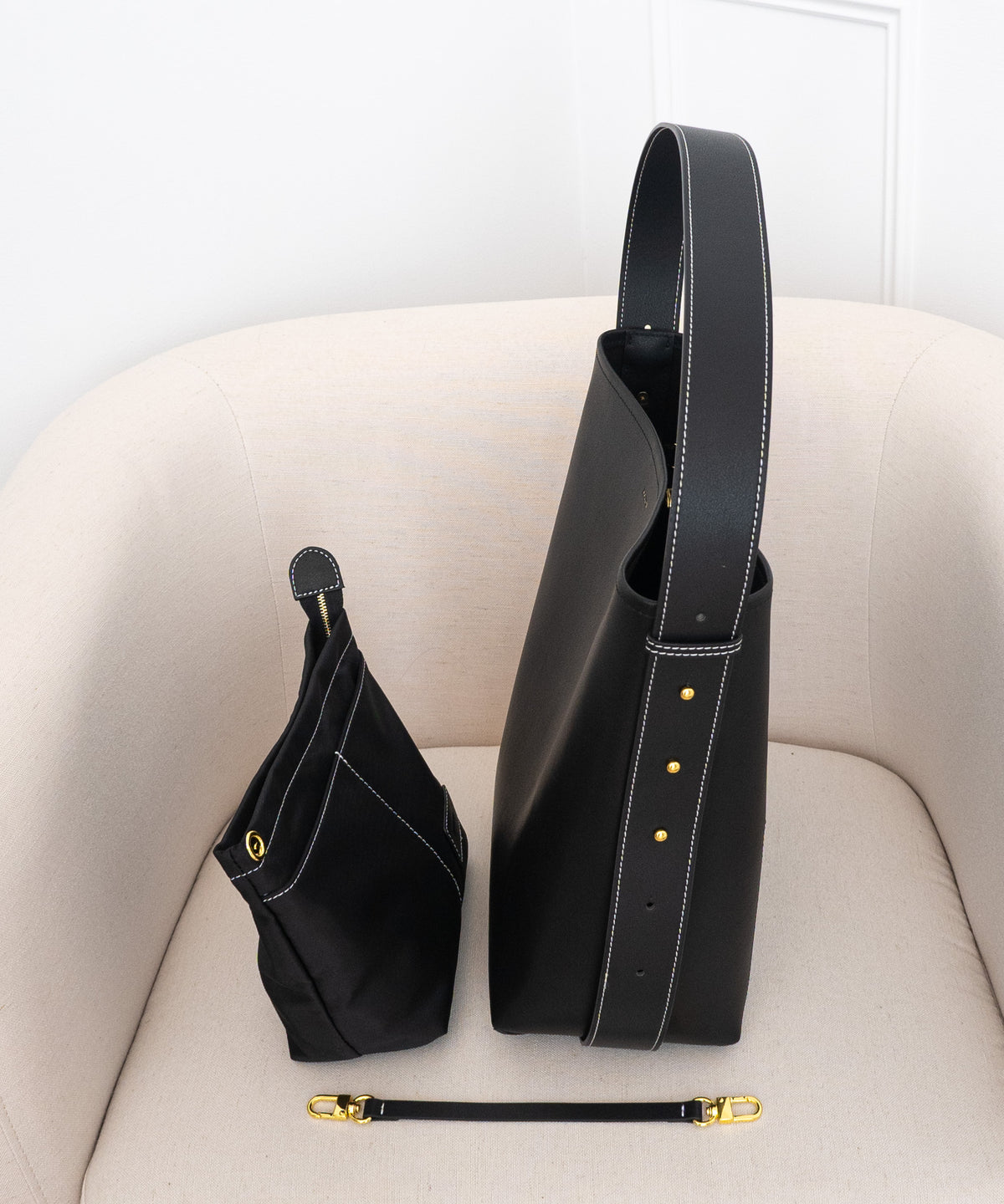 What's included with the AALLYN Jolina Bucket Tote: the tote, crossbody strap, and interior pouch